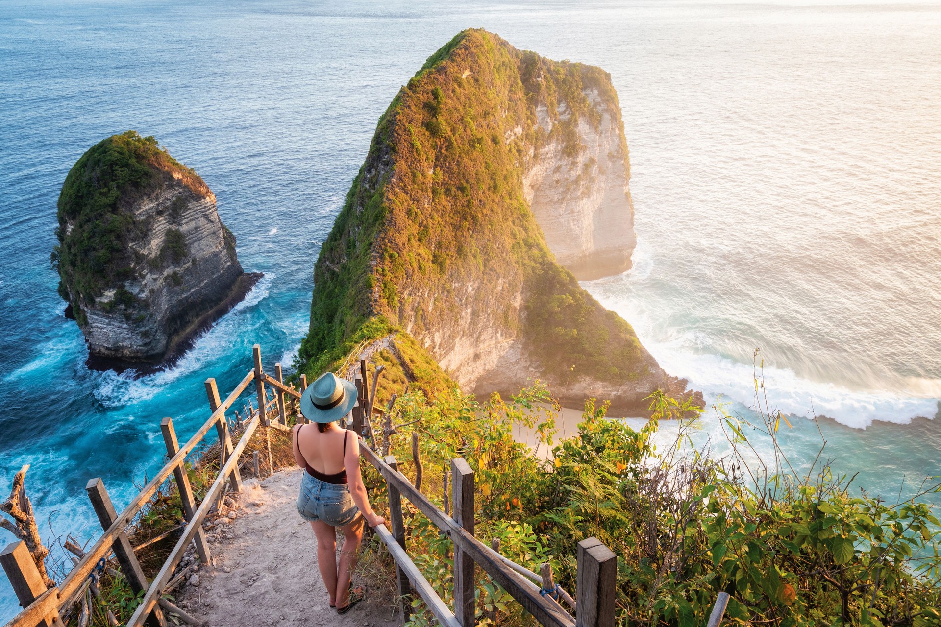 Bali, Indonesia, Traveler Watching the Sunset at Kelingking Beach in Nusa Penida Island